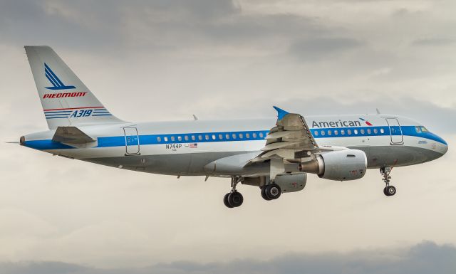 Airbus A319 (N744P) - Piedmont retro on short finals for runway 23 at YYZ on a grey day for plane spotting