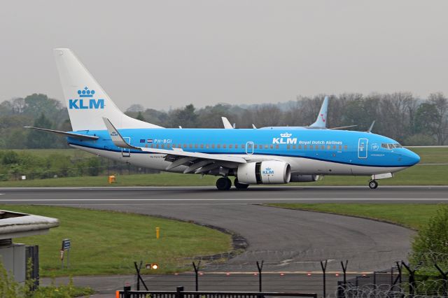 Boeing 737-700 (PH-BGI) - Early KLM of the day, KLM1073 passes the fire station on 05R after arriving from Amsterdam