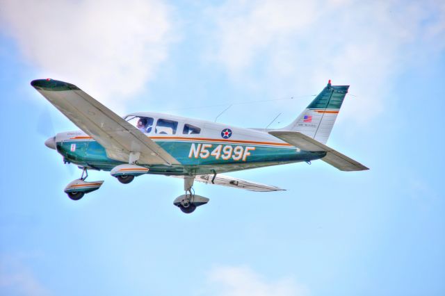 Piper Cherokee (N5499F) - Taking off to the east into scattered clouds