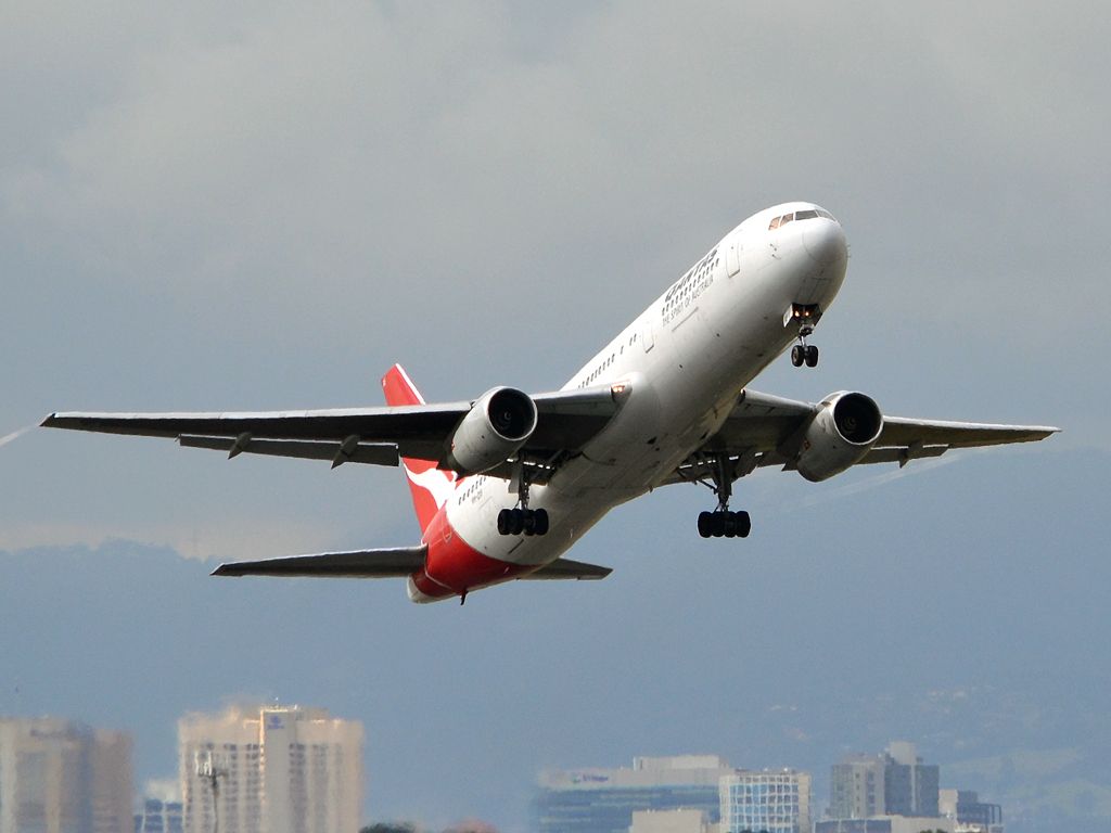 BOEING 767-300 (VH-ZXF) - Getting airborne off runway 23 0n a gloomy, cold winters day. Wednesday 4th July 2012.