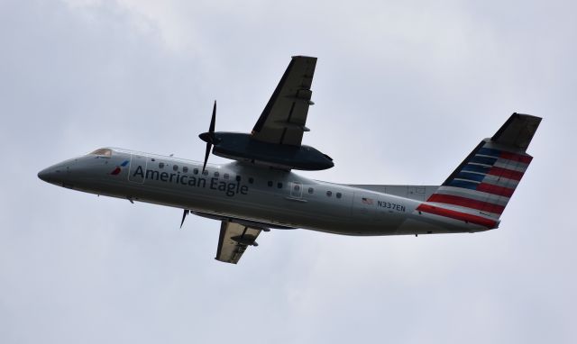 de Havilland Dash 8-300 (N337EN) - A heartbreaking sight.  One of the last flights of the Dash to depart CLT.  From the overlook, 7/4/18.