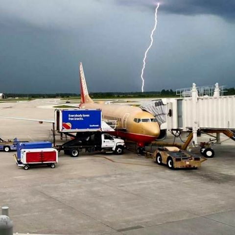 Boeing 737-700 (N711HK) - While shooting the picture I didnt notice the lighting did strike. Typical Summer Afternoon at KMCO.