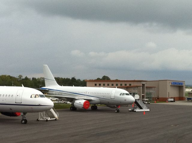 Airbus A319 — - OmniFlight (White Airways) A319 sits on the Wilson Air Center CHA ramp on Sept 22-24, 2011