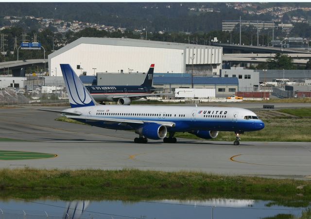 Boeing 757-200 (N502UA) - KSFO - Apr 15, 2005 - United 757 rolling to Runway 1R for points east...view from the Westin Hotel rooms facing SFO. click full to enlarge.