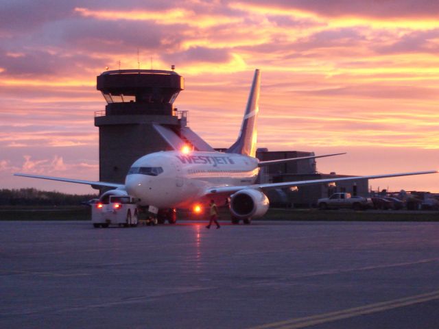 BOEING 737-600 — - WestJet Boeing 737-600 completed pushback and about ready to depart Fort McMurray, Alberta for Edmonton, Alberta as the sun sets over the Oilsands city