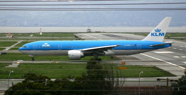 Boeing 777-200 (PH-BQI) - KSFO - daily flight from AMS rolls off 19L to hold short of 19R for landing traffic - click full.