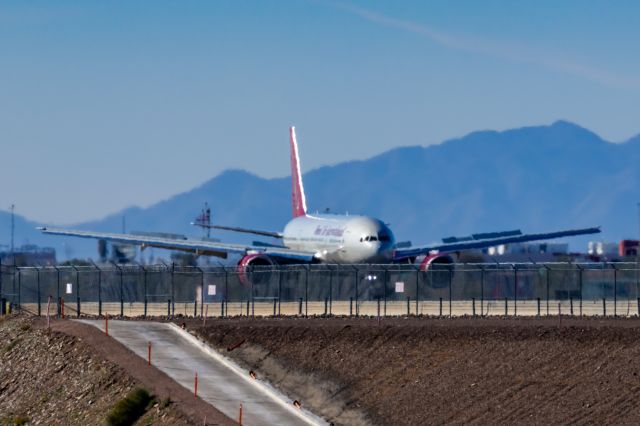 Boeing 777-200 (N828AX) - An Omni Air International 777-200 landing at PHX on 2/10/23 during the Super Bowl rush. Taken with a Canon R7 and Canon EF 100-400 II L lens.