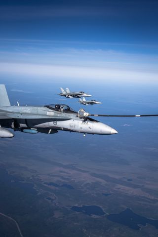 — — - A three ship of CF-18 Hornets from 425 Squadron out of 3 Wing CFB Bagotville tank from a Colombian Air Force KC-767 during Exercise Maple Flag 46 held and 4 Wing CFB Cold Lake.