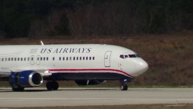 BOEING 737-400 (N449US) - N449US with reversers deployed on landing rollout runway 5L.