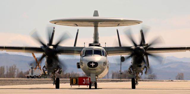 Grumman E-2 Hawkeye (16-4352) - A steady 30  MPH crosswind was not powerful enough to stop this NAWDC E-2C Hawkeye (164352) from taking off from NAS Fallons runway 31R about four minutes after this scene was captured as it sat notched with four Super Hornets on taxiway Bravo.