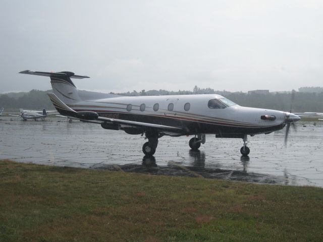 Pilatus PC-12 (N55NX) - As soon as this PC12s wheels touched the ground, it started pouring. Once they unloaded, it stopped.