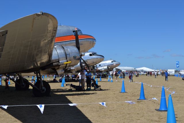 Douglas DC-3 — - A nice lineup of 3 DC-3s at the Australian International Airshow 2013, note the RAAF Wedgetail in the background.