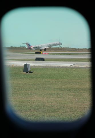 Canadair Regional Jet CRJ-900 (N563NN) - 10/22/16 Rotating from Rwy 36C, love the way it framed in window across the cabin