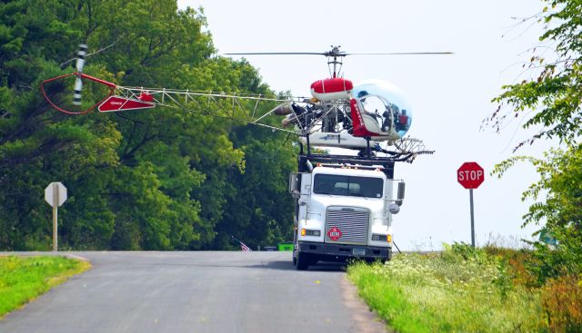 N8542D — - A crop-dusting helicopter operated by Scotts helicopter services lands to fill up the spray tank.   