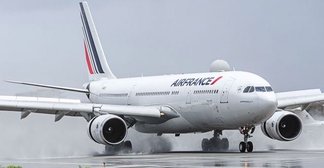 Airbus A330-200 (F-GZCJ) - Air France Airbus A330-200 F-GZCJ slowing down on a wet runaway after the passing showers at TNCM St Maarten.br /23-06-2018