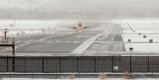 Boeing 737-700 (N262WN) - Blasting a little snow and a lot of water from the surface of runway 34L, Southwest's N262WN has rotated and is breaking contact with the runway to begin a morning (8:10 AM) flight from Reno to Las Vegas.