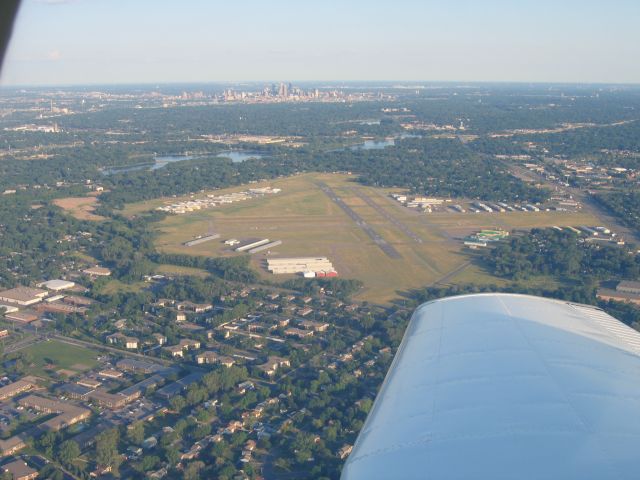 Piper Cherokee (N4017F) - Downwind for Landing on Runway 24R at Crystal Airport. Downtown Minneapolis is in the back ground.