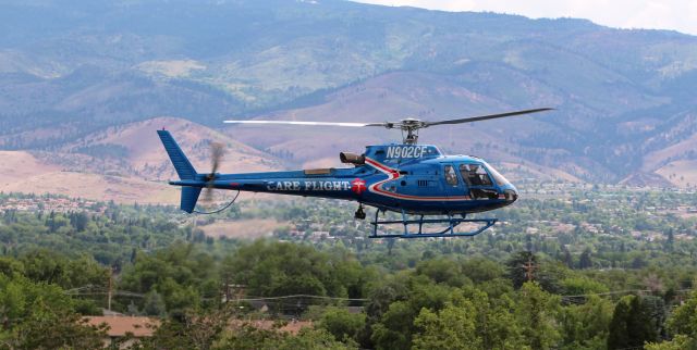 Eurocopter AS-350 AStar (N902CF) - REMSA's Care Flight helicopter N902CF is captured in this air-to-air shot (I was in REMSA's Care Flight AS50 N901CF*) as it was with us while both helicopters were approaching the NV69 medical heliport.br /* I was aboard by request taking publicity photos. * 1f5/47/@2