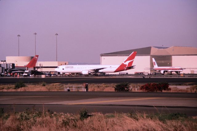 BOEING 767-300 — - KSFO - 1993 or 1994 late PM photo from the dirt parking lot adjacent to the 1LR departure runways at SFO - the date stamp on the color slide show Feb 1994 when film was developed, though I think I took this in late 1993. This was when SFO had QANTAS 767-3ER service that I think was SYD-LAX-SFO and back, This flight did not last that long at SFO. This and a few others are the only pictures I have of a QANTAS 767-3 at SFO. This jet is on push back for another gate from the old International dock at San Francisco. I am unable to read the reg, as a long distance shot with a 28-300mm - Color slide converted to digital.