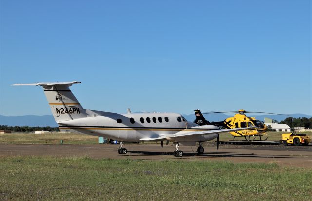 Beechcraft Super King Air 200 (N246PH) - KRDD - May 2020 shows infrequent visitor N246PH at Redding - when the temperature heats up here for summer the PHi ramp crews hook portable air conditioning units up the the Helicopter and fixed wing as it can be a real frying pan here in the summer months with temps reaching 120 on the pavement.