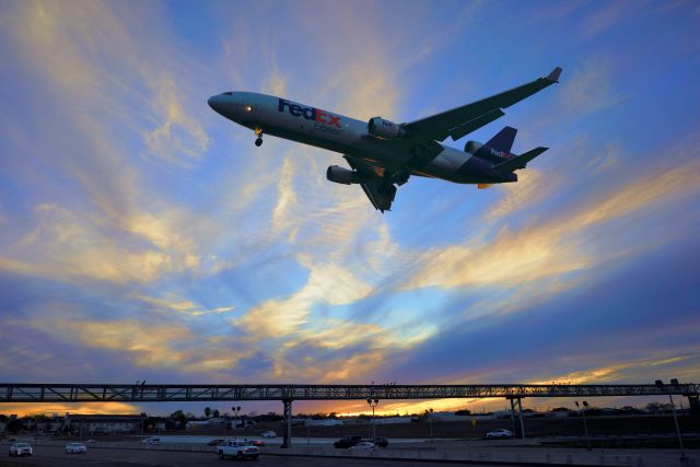 Boeing MD-11 (N595FE) - 12R approach at sunset.