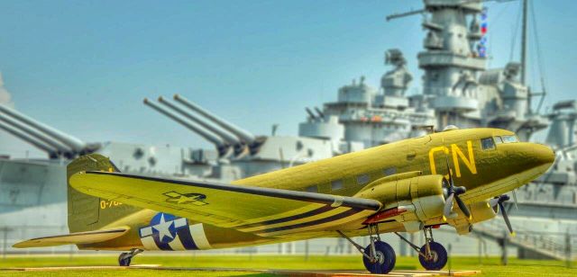 Douglas DC-3 — - USS Alabama sits in the background of this old bird...