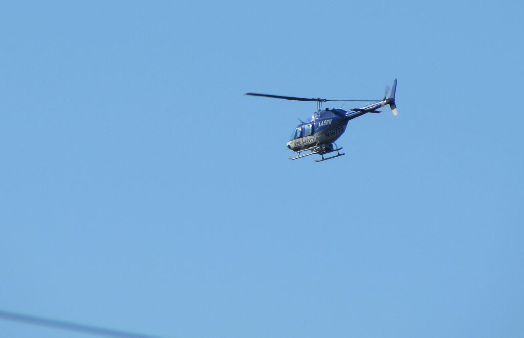 N16770 — - Pipe survey helicopter performing low-flight survey of PG&E Gas Pipelines in Prunedale, California.