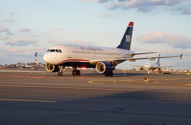 Airbus A319 (N762US) - RWY27 sunset arrival