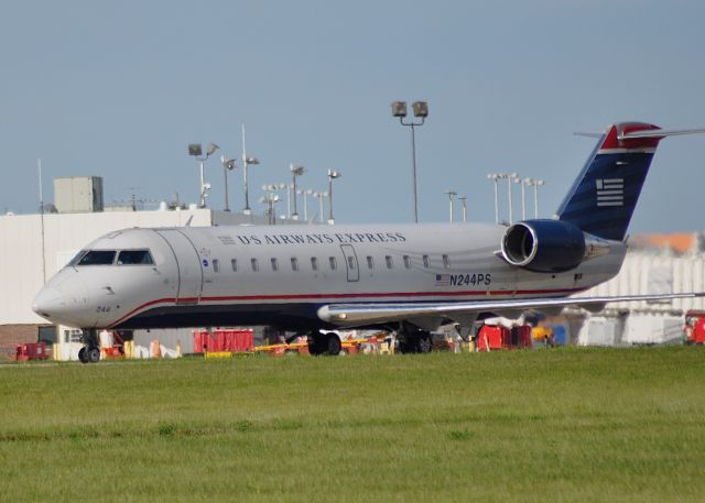 Canadair Regional Jet CRJ-200 (N244PS) - PSA Airlines Regional Jet CRJ-200ER {N244PS}, operating as U.S Airways Express, taxis towards Runway 24 Left at the Dayton International Airport {DAY} bound for the Charlotte/Douglas International Airport on June 21, 2015.