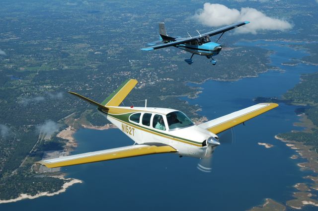 Beechcraft 35 Bonanza (N152T) - Taken from the back of my Six, flying over Folsom Lake CA in 2005. Mark is flying his V35, Tim is looking down in the passenger seat! John is flying his dads C175 (named Emma) in formation. This photo was featured on the front cover of the Second July Issue, 2005, Trade-A-Plane. Photo copyright Andy Robinson