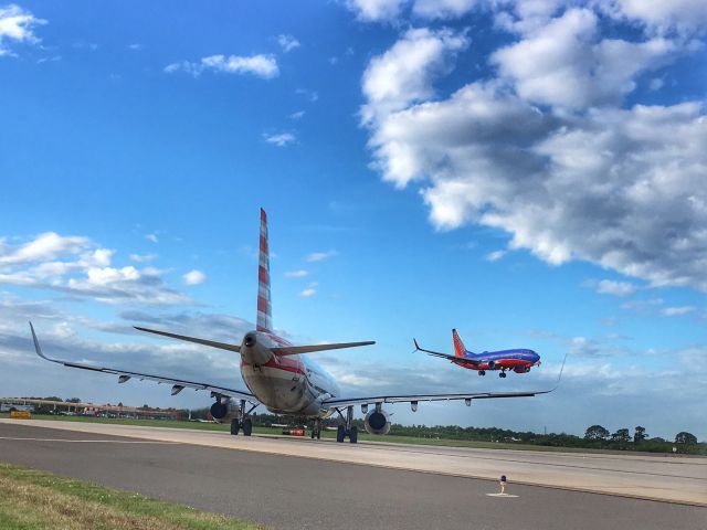 — — - American Airlines waiting to depart runway 1L, while Southwest arrives in TPA.