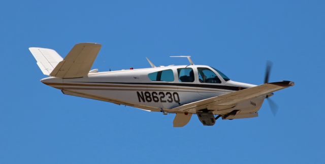 Beechcraft 35 Bonanza (N8623Q) - The wheels are in the wells and the doors are closing as this 1964 Beech S35 Bonanza departs.