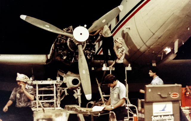 Douglas DC-3 (N32PB) - A disc and wobble check in progress on a Pratt and Whitney R-1830. The guys working the lower cylinders got dripped on and had to cover up as much as possible... :) Provincetown Boston Airlines HYA MX 1983 Photo credit to Steve Collins- PBA Avionics, who appropriated my camera from my toolbox and snapped this picture.