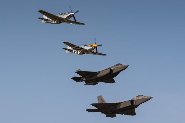 Lockheed F-22 Raptor (08-4156) - An F-22, F-35, and two P-51s fly in formation over the skies of Oshkosh, Wisconsin during EAA Airventure 2019.