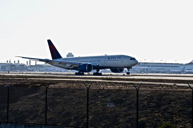 Boeing 777-200 (N710DN) - Just touching down on 24R after a long haul from Tokyo NRT.