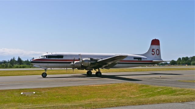 Douglas DC-6 (N501XP) - N501XP a DC-6B (Ser#45177) on Taxiway A prior to departing for PAFA / FAI on 6/6/14. This aircraft is an ex-CONAIR water bomber #C-GKUG. Thanks to member moonm for his research.  a rel=nofollow href=http://www.conair.ca/galleryhttp://www.conair.ca/gallery/a