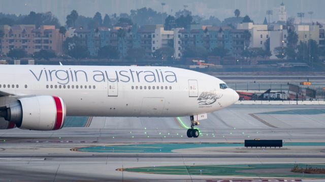 BOEING 777-300ER (VH-VPD) - Taxiing to the gate after a morning arrival on 24R from Sydneybr /11/12/17