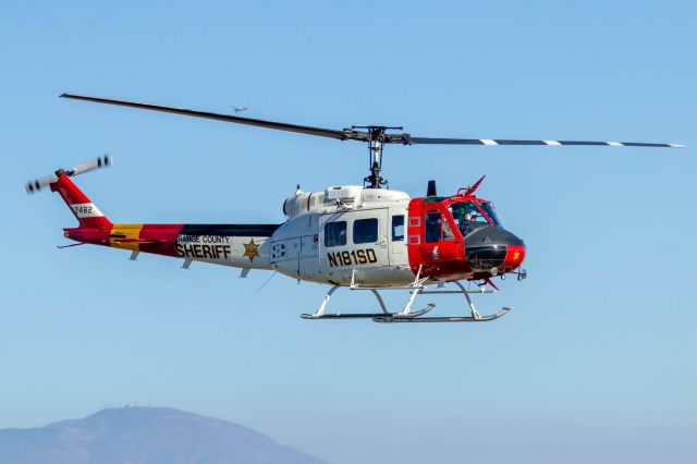 Bell UH-1V Iroquois (N181SD) - It almost looks as though a Cessna is landing on the left blade.