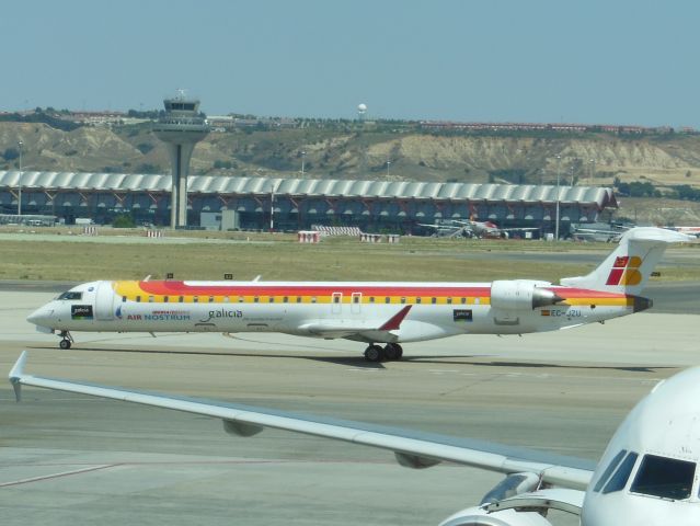 Canadair Regional Jet CRJ-900 (EC-JZU) - Iberia Regional / Air Nostrum (IB/YW) EC-JZU CRJ-900 [cn15115]br /Madrid Barajas (MAD). Pictured taxiing in the Spanish summer sunshine, this Air Nostrum Regional Jet has ‘Region of Galicia’ marketing titles.  br /Taken from the Terminalbr /2013 06 24  a rel=nofollow href=http://alphayankee.smugmug.com/Airlines-and-Airliners-Portfolio/Airlines/EuropeanAirlinehttps://alphayankee.smugmug.com/Airlines-and-Airliners-Portfolio/Airlines/EuropeanAirline/a