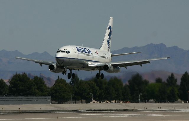 Boeing 737-200 (XA-TWO) - KLAS - Aviasca 737-200 over the numbers on 25L at Las Vegas,