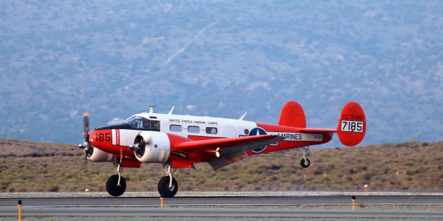 Beechcraft 18 (N7185) - A Beechcraft C-45 Expeditor (N7185) touching down at Reno Stead Airport as it makes an early evening arrival to go on display in the NAHI static display section at the 2021 National Championship Air Races (aka: Reno Air Races).