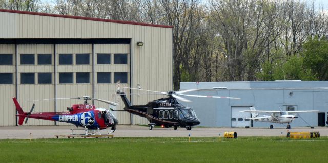 BELL-AGUSTA AB-139 (N223KR) - Center of attention is this 2013 AgustaWestland 139 Rotorcraft about to depart in the Spring of 2022. Also shown is a Eurocopter AS350 and a Cessna 150L.