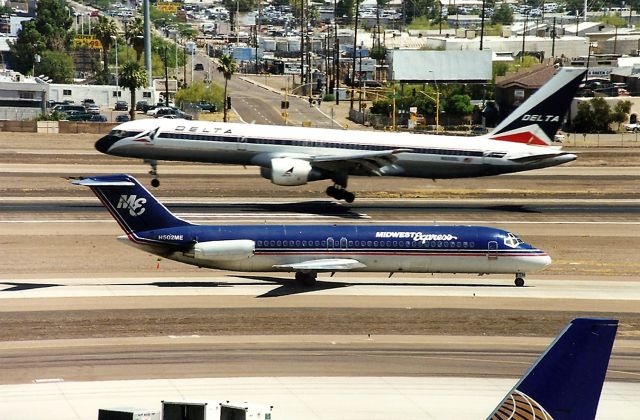 Douglas DC-9-10 (N502ME) - KPHX - Midwest Express taxi to the hold point as the Delta 757 is ready to smoke the tires.