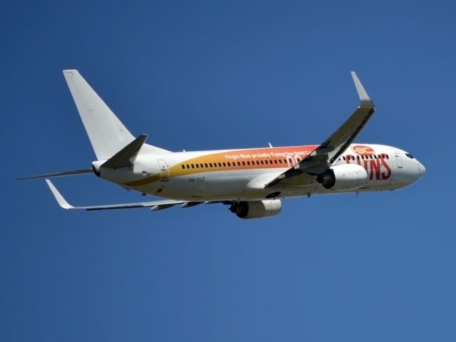 Boeing 737-800 (VH-VUZ) - Special livery displaying Virgin Blues sponsorship of the Gold Coast Suns Football Club. Most appropriate for this flight as this bird was heading for the tropical sunshine of Bali.