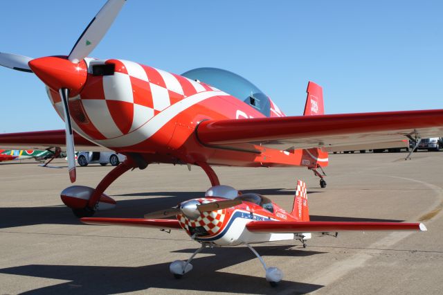 EXTRA EA-300 (N772TA) - EXTRA FLUGZEUGPRODUKTIONS-UND EA 300/L (ORACLE paint scheme - 2007 model) pictured with Great Planes R/C 1/4 scale Extra 300S model. (Patty Wagstaff N68PW Goodrich sponsored paint scheme - 2003)br /br /Photo taken at the 2013 Alliance Air Show in Fort Worth, TX after the FW Thunderbirds R/C club demonstration.