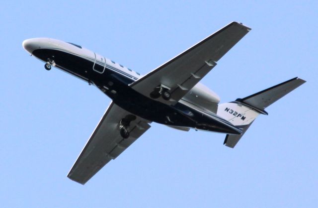 Cessna Citation CJ4 (N32PM) - Wheels down, making final approach to Orlando International. MCObr /Clear skies, runway in sight.