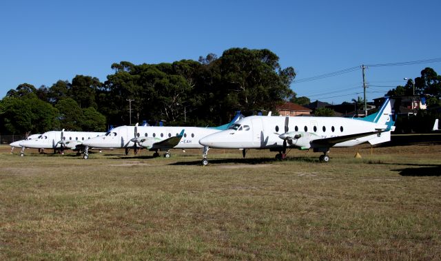 Beechcraft 1900 (ZK-EAB) - L to R ZK-EAN /EAE /EAH /EAB in open storage at Bankstown Airport