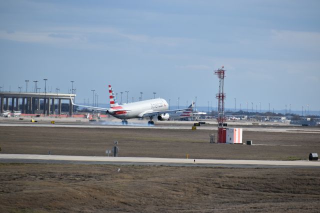 Airbus A321 (N990AU) - Taken at the Founders Plaza, while watching planes land onto runway 18R