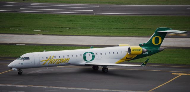 Canadair Regional Jet CRJ-700 (N611QX) - Horizon Air CRJ-700 with University of Oregon livery taxing to park at Portland International Airport.