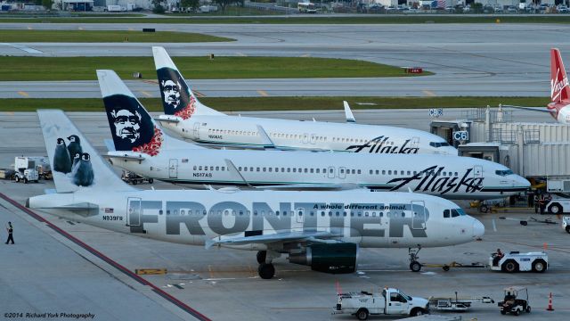 Airbus A319 (N939FR) - Special Tails @ FLL - Frontier Penguins, along with two Leid Alaska Airlines 737-800s (N517AS & N508AS).